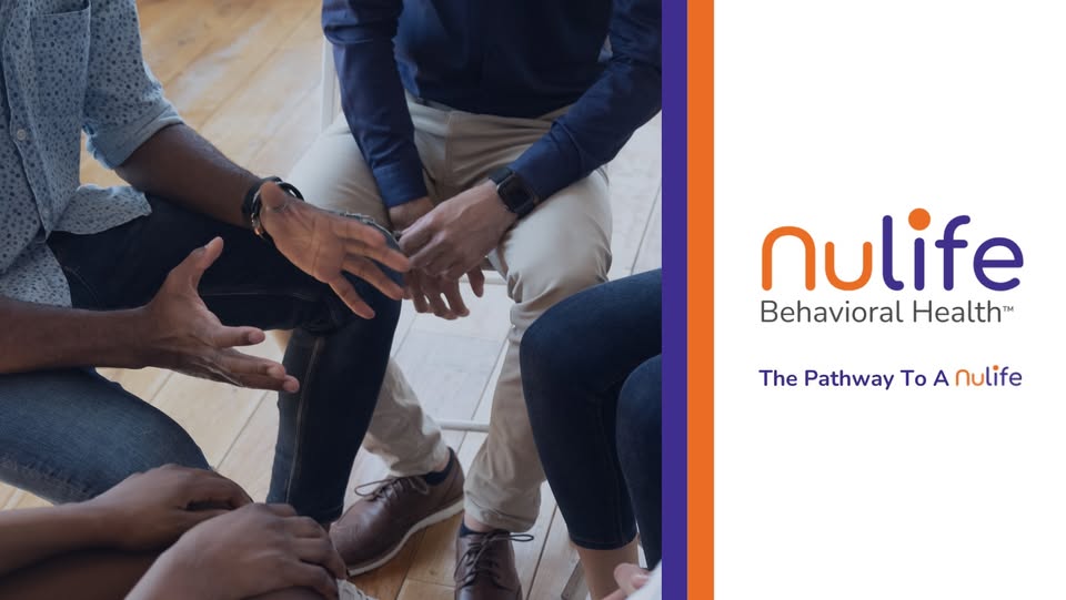 Small group of adults sitting in a circle during a therapy session