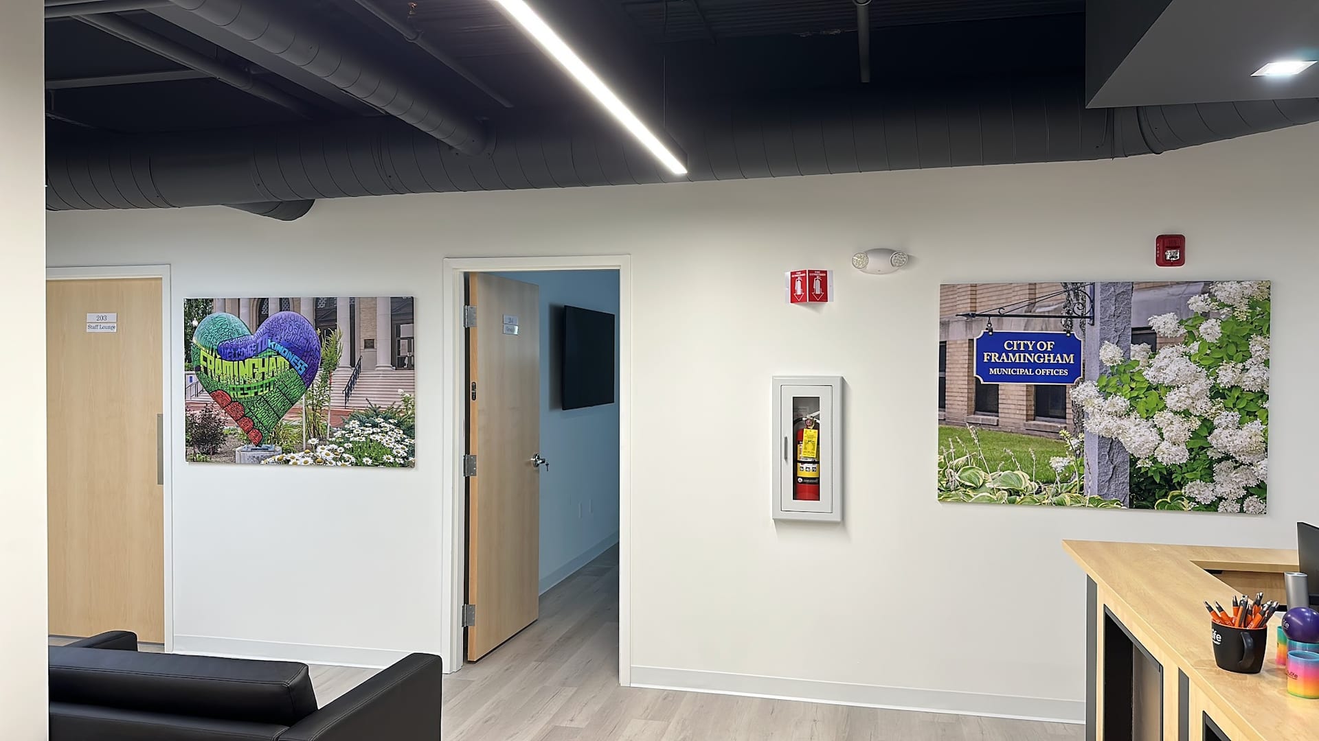 Modern lobby with City of Framingham artwork and fire extinguisher cabinet