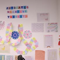 Wall display with automatic negative thoughts banner and colorful patient artwork