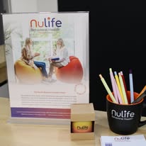 Nulife Behavioral Health branded desk display with pencil holder and brochure