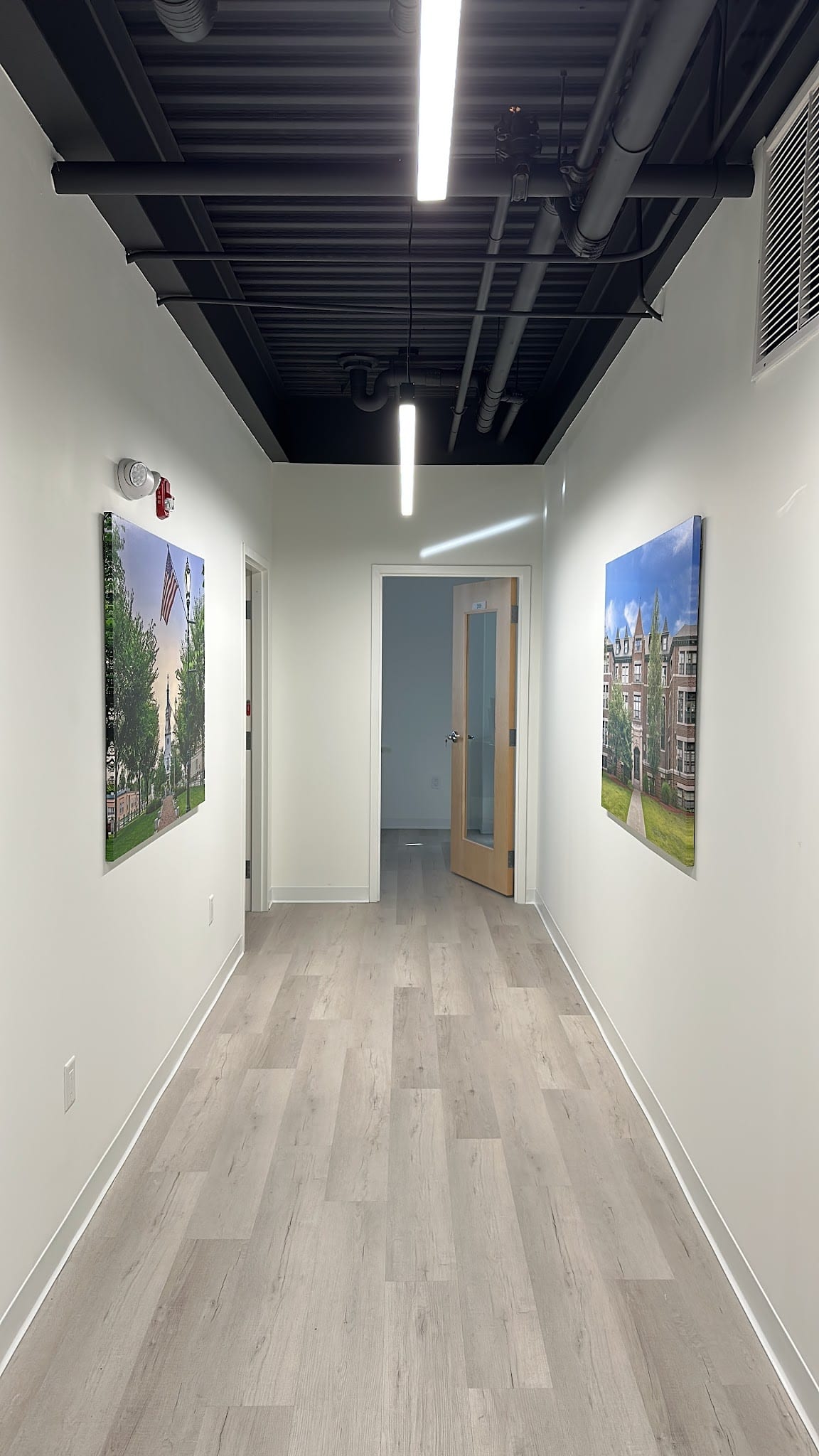 Clean modern hallway with wood floors and local Framingham photography wall art