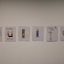Row of illustrated cards mounted on a white gallery wall